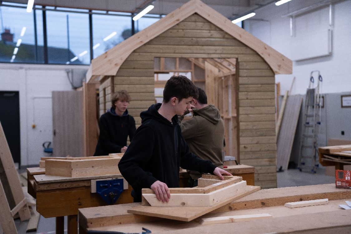 Students at work in a college carpentry workshop